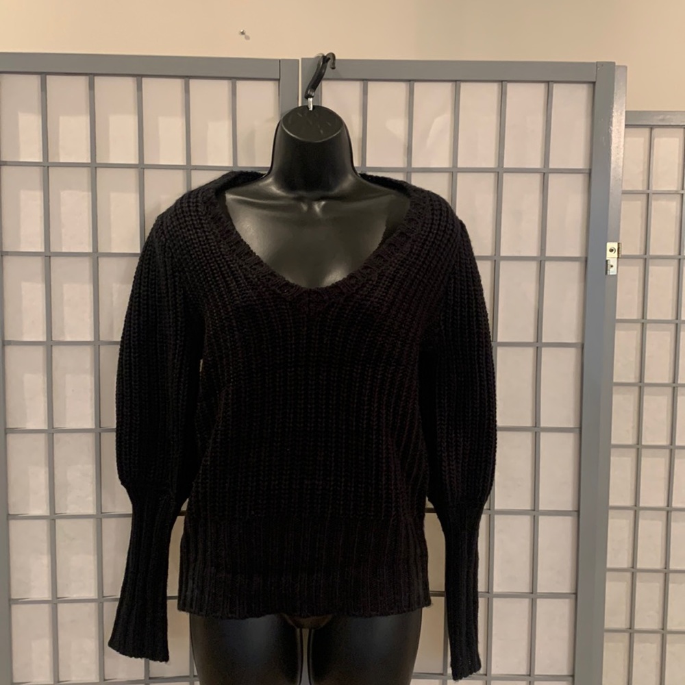 Black Venus V neck sweater with puff shoulder and fitted forearms. Super sexy on